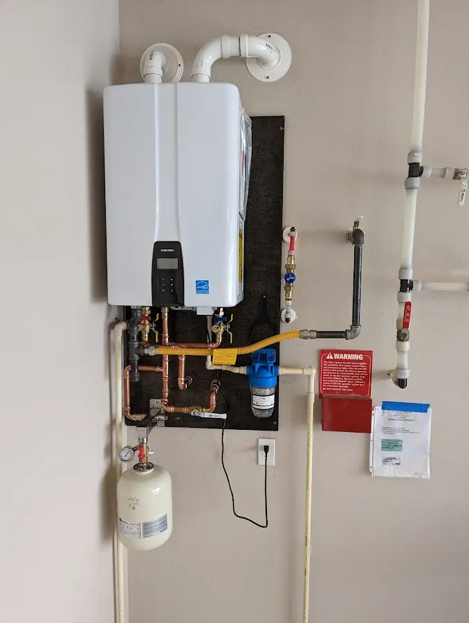 Professional plumber installing copper piping in a Pontotoc home